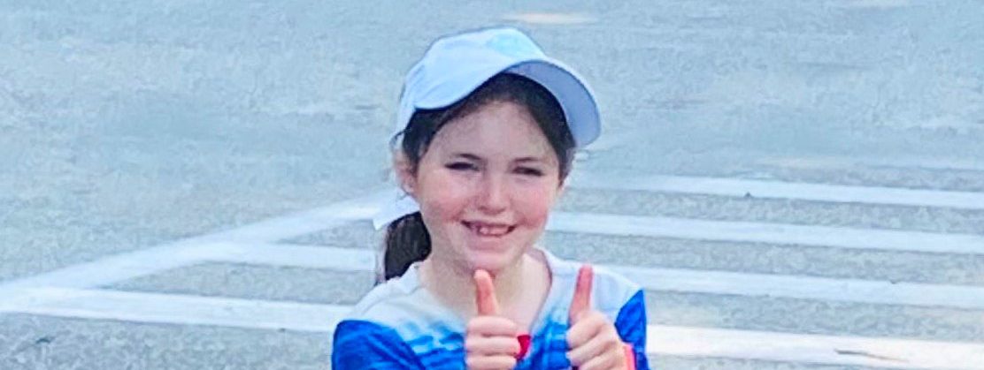 smiling-young-girl-in-blue-shirt-gives-double-thumbs-up