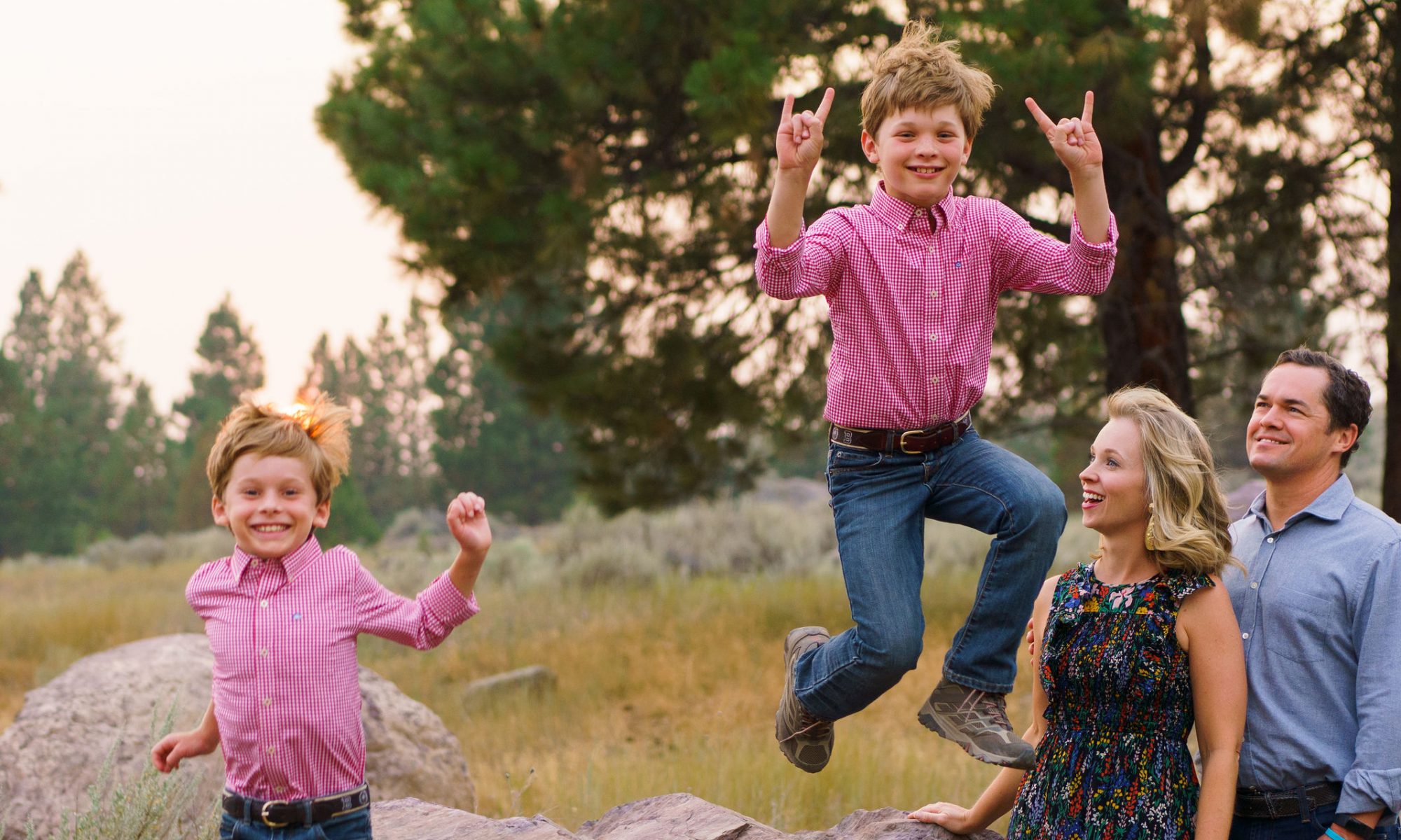 two-small-boys-jump-for-joy-as-parents-watch
