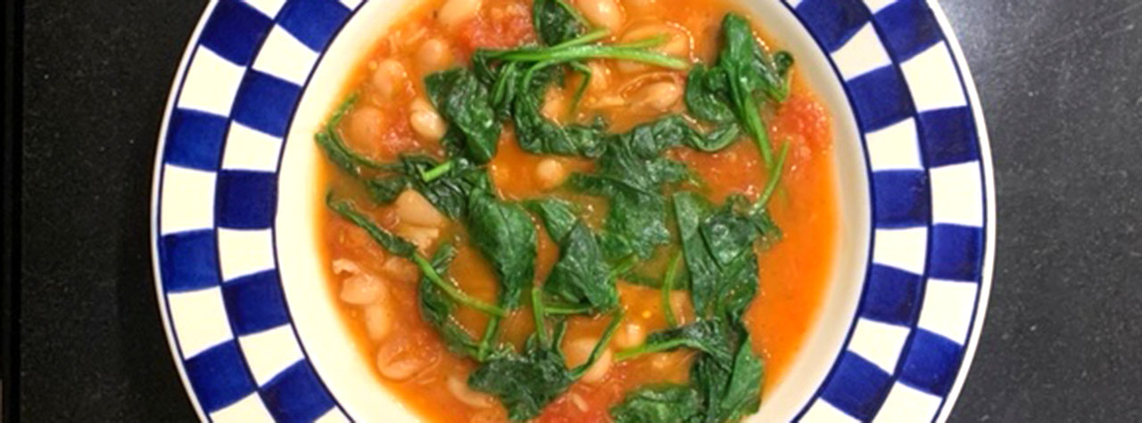 easy-tuscan-bean-soup-tomato-based-with-white-beans-spinach-displayed-in-blue-white-checked-soup-bowl