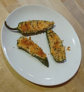3 jalapeno peppers stuffed with a cheese mixture and baked with bread crumbs on top. Jalapeno Popper Finger Food Recipe from Allergy Dragon.