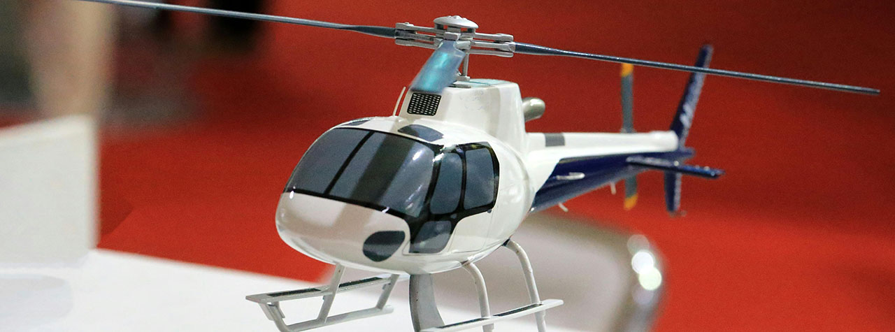 White toy helicopter with red background. Image by Saturnus99 on Pexels.