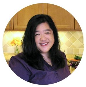 Headshot of Sharon Wong, founder of Nut Free Wok, and food allergy advocate, recipe innovator, and author. In her kitchen creating amazing Asian food.