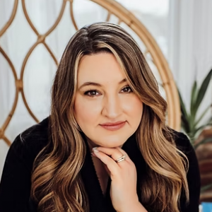 Headshot of Tamara Hubbard, The Food Allergy Counselor. Pretty brown haired woman with green eyes sits in high backed chair and smiles.