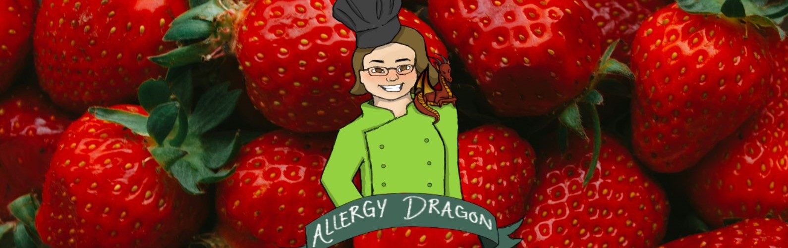 Ripe red strawberries. Allergy Dragon logo of a smiling female chef in a green chef's jacket and grey chef's toque with a small, dark red dragon on her left shoulder is superimposed over the strawberries. Image courtesy of Moon Moons on Unsplash, Allergy Dragon, and Allergy Force on Canva.